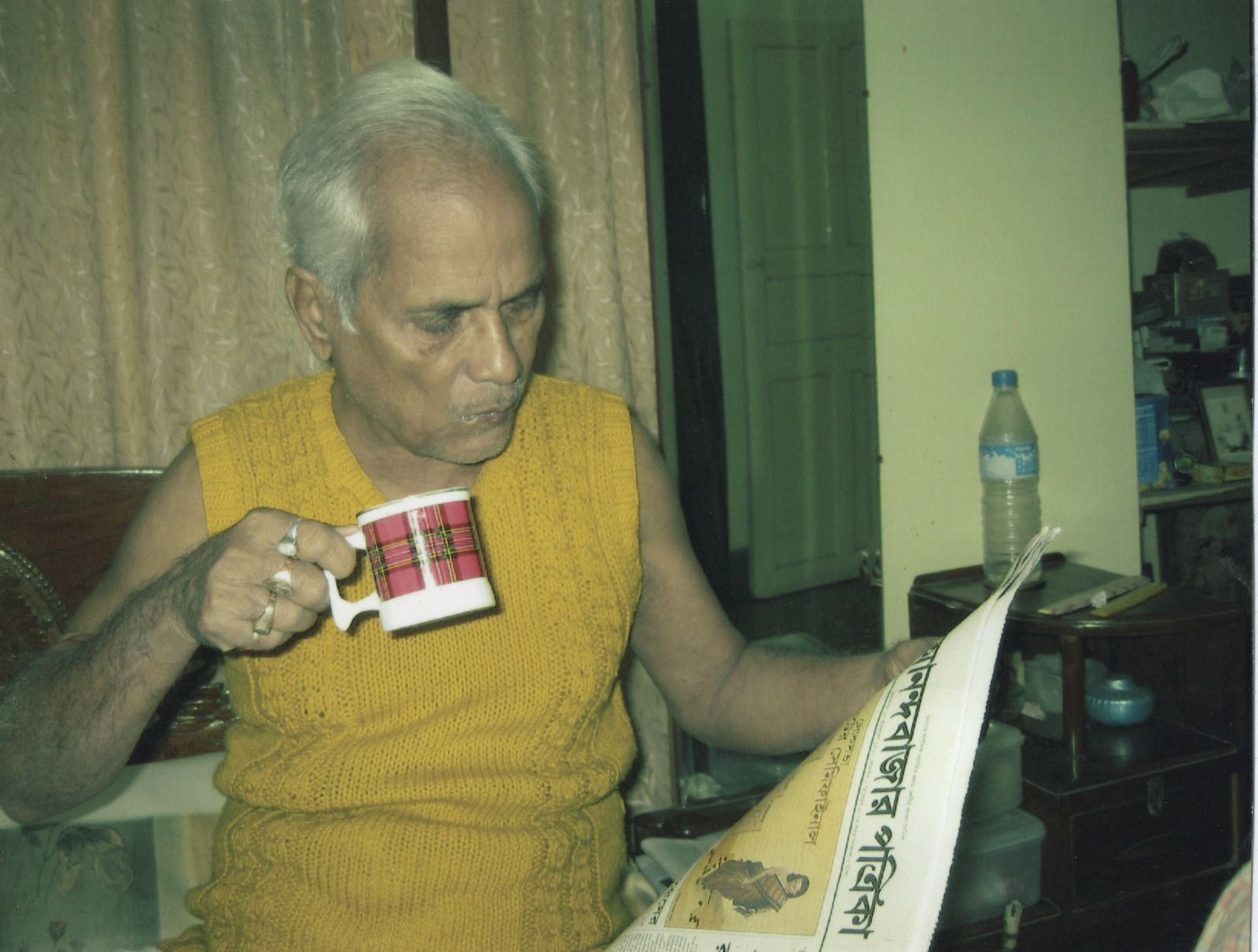Old picture of my father who was alive when he was reading the newspaper